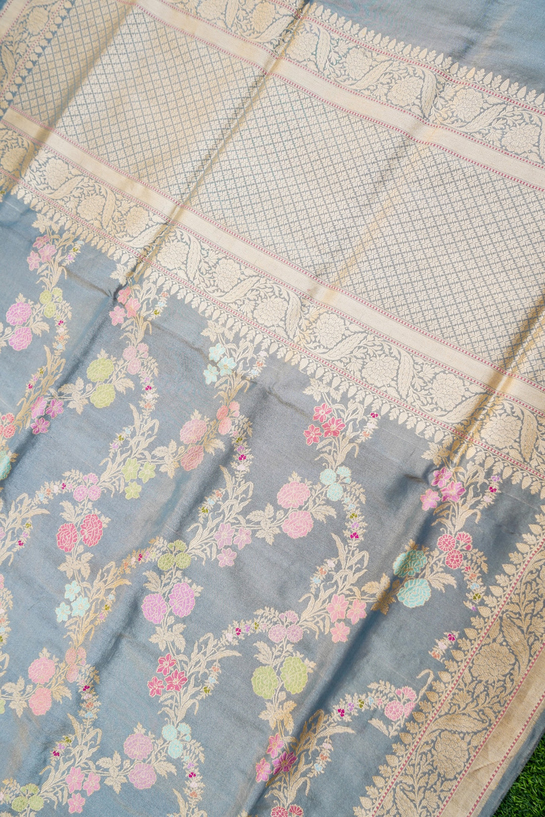 Floral patterned fabric with a textured border on a blue background