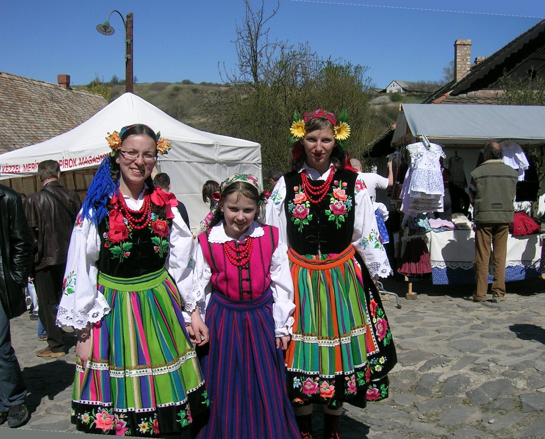 Łowicz folk costume with rainbow-striped woven wool skirt, Poland — via Wikimedia Commons