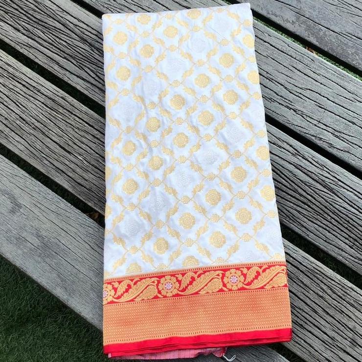 A handwoven Banarasi Jangla in pure Katan silk, densely woven with floral and bird motifs in gold zari