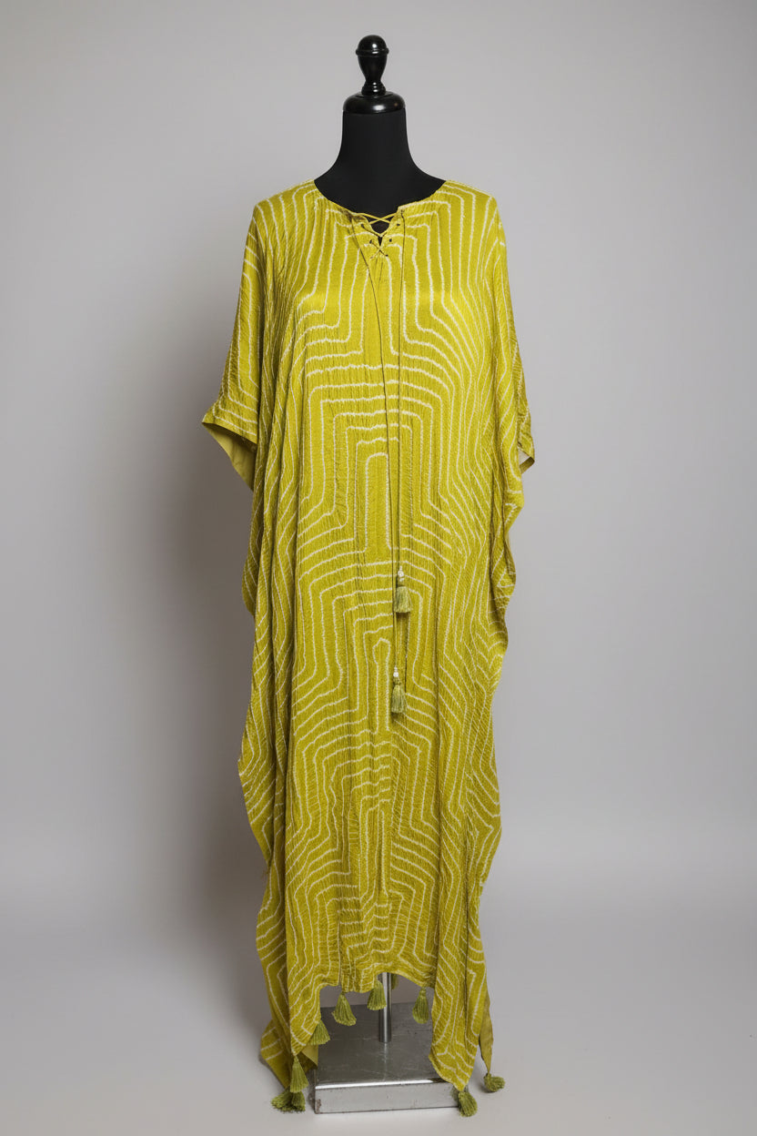 Yellow patterned dress on a mannequin in a store setting