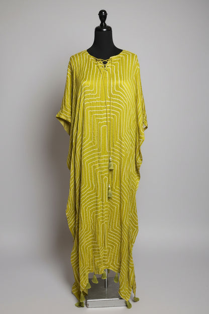Yellow patterned dress on a mannequin in a store setting