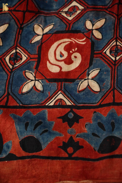 Close-up of a patterned fabric with geometric design and central emblem.