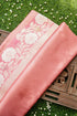 Pink fabric with floral patterns on a decorative surface